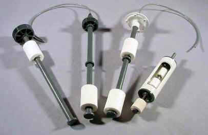 Four assembled liquid level sensor units built from molded plastic floats, stems and end fittings
